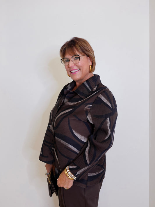 woman wearing a liv chocolate brown Parisian pleated blouse. 