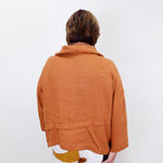 Person wearing a brown jacket on a white background