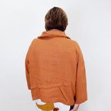 Person wearing a brown jacket on a white background