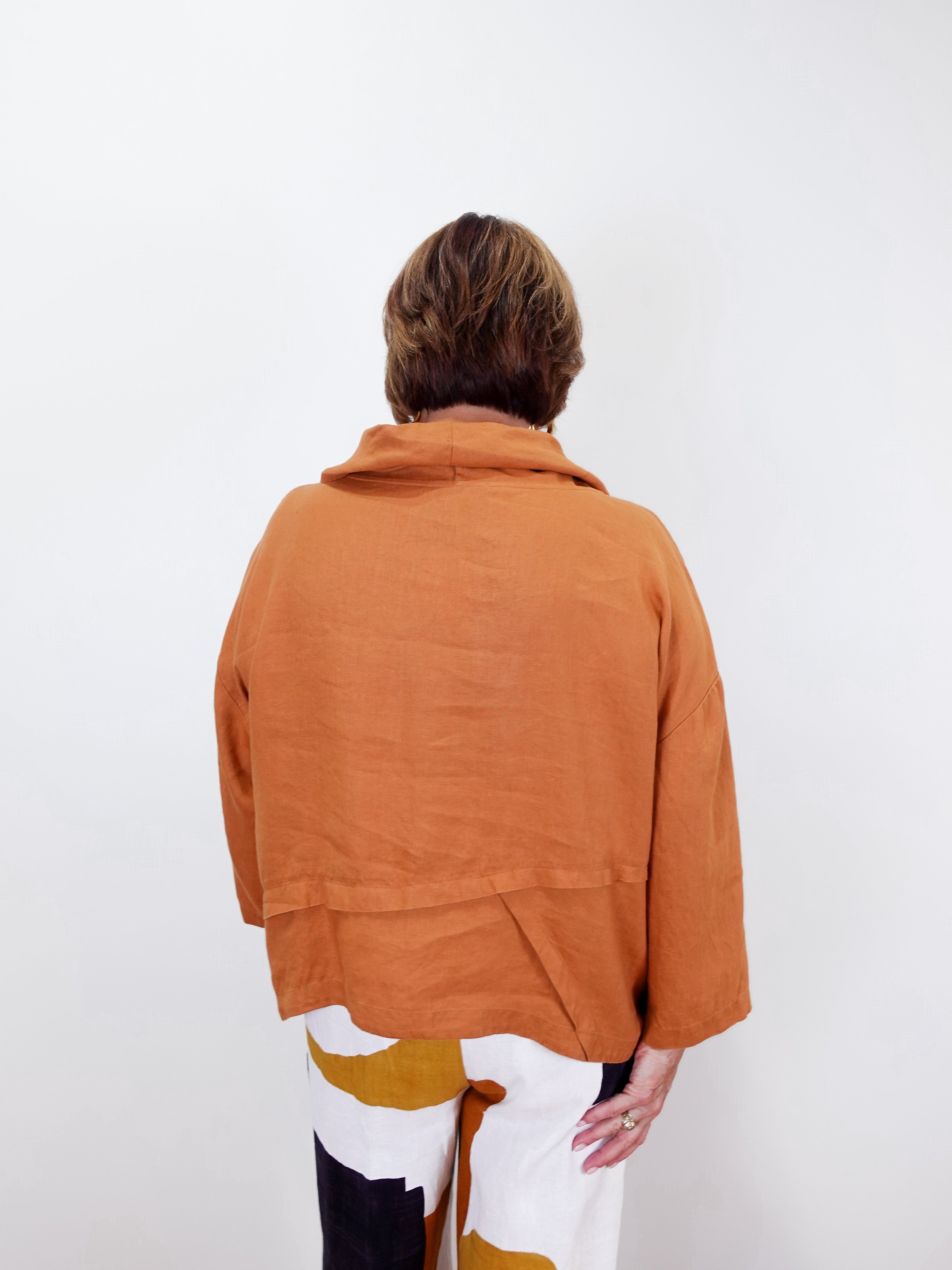 Person wearing a brown jacket on a white background
