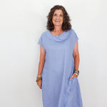 Woman wearing a light blue dress against a white background