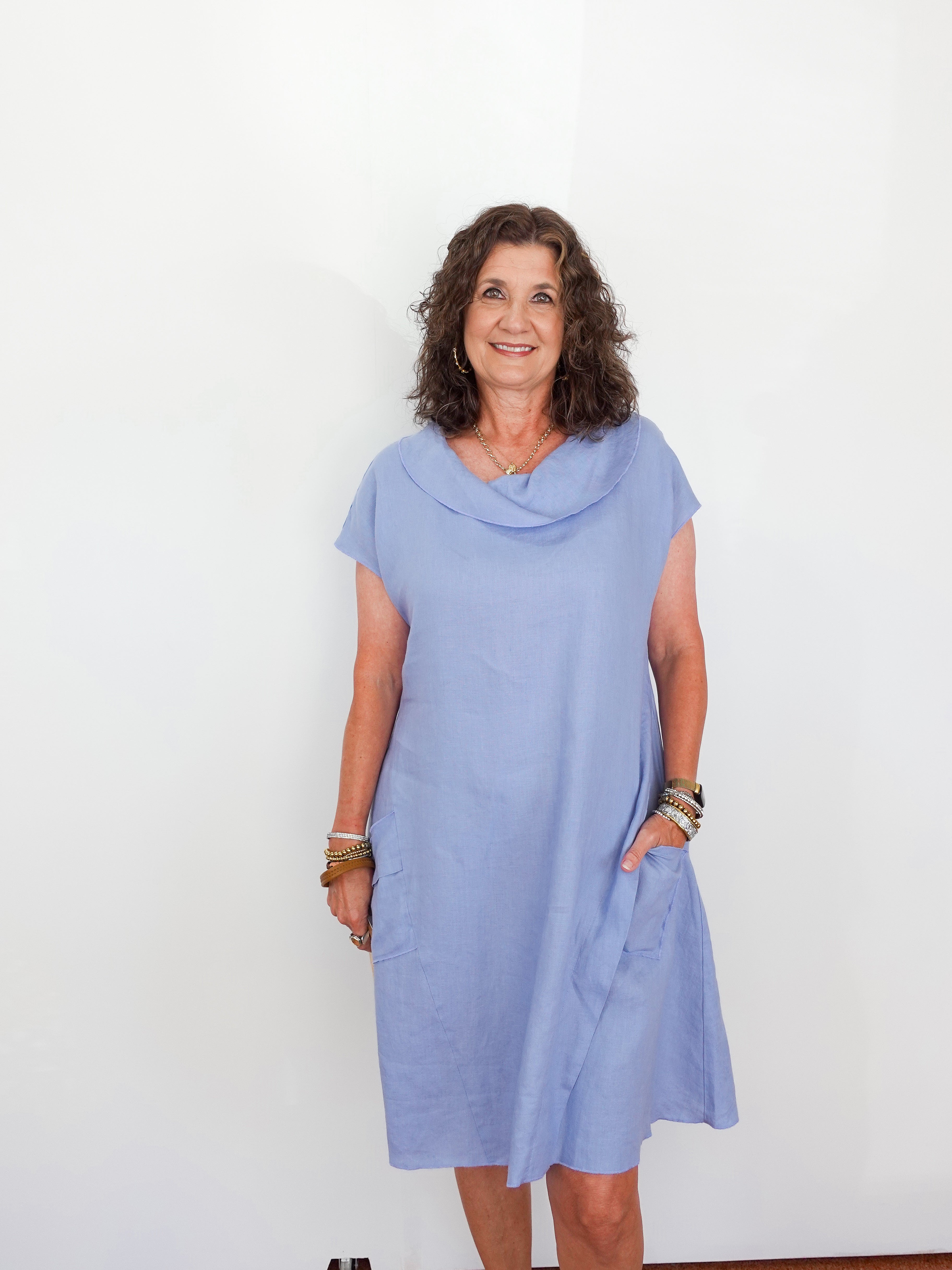 Woman wearing a light blue dress against a white background