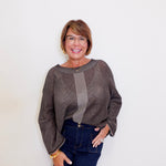 Women wearing a brown reversible mesh go to topper from liv against a white background. 