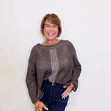Women wearing a brown reversible mesh go to topper from liv against a white background. 