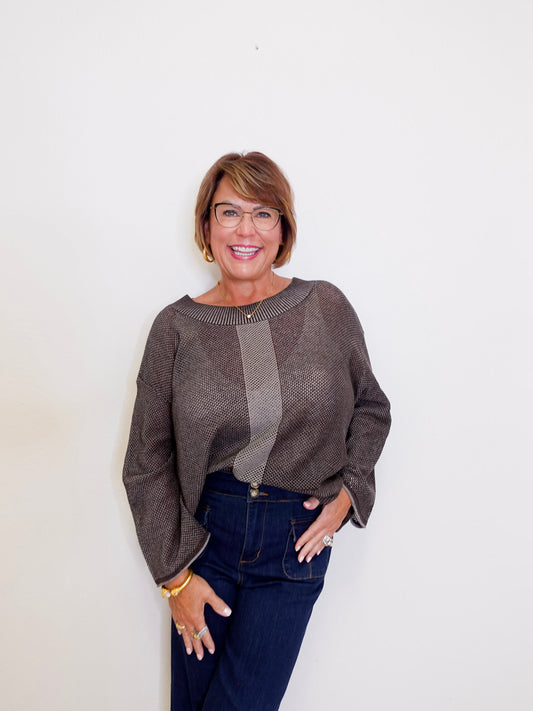 Women wearing a brown reversible mesh go to topper from liv against a white background. 
