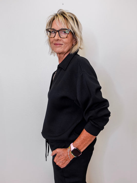 women modeling a black v neck sweatshirt in black. 