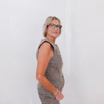 Woman wearing a patterned dress against a white background