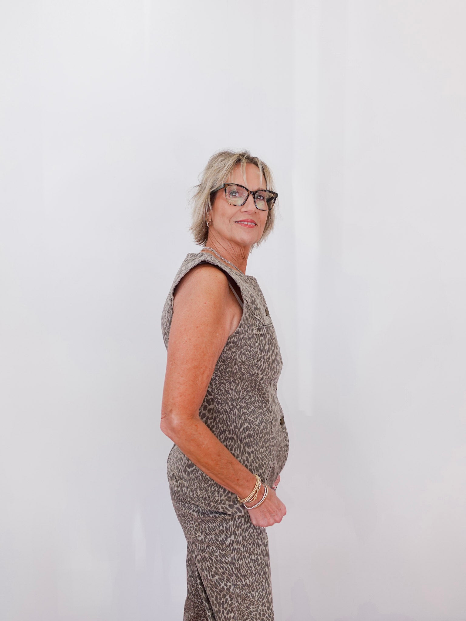 Woman wearing a patterned dress against a white background