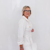 Person wearing a white outfit with a plain background