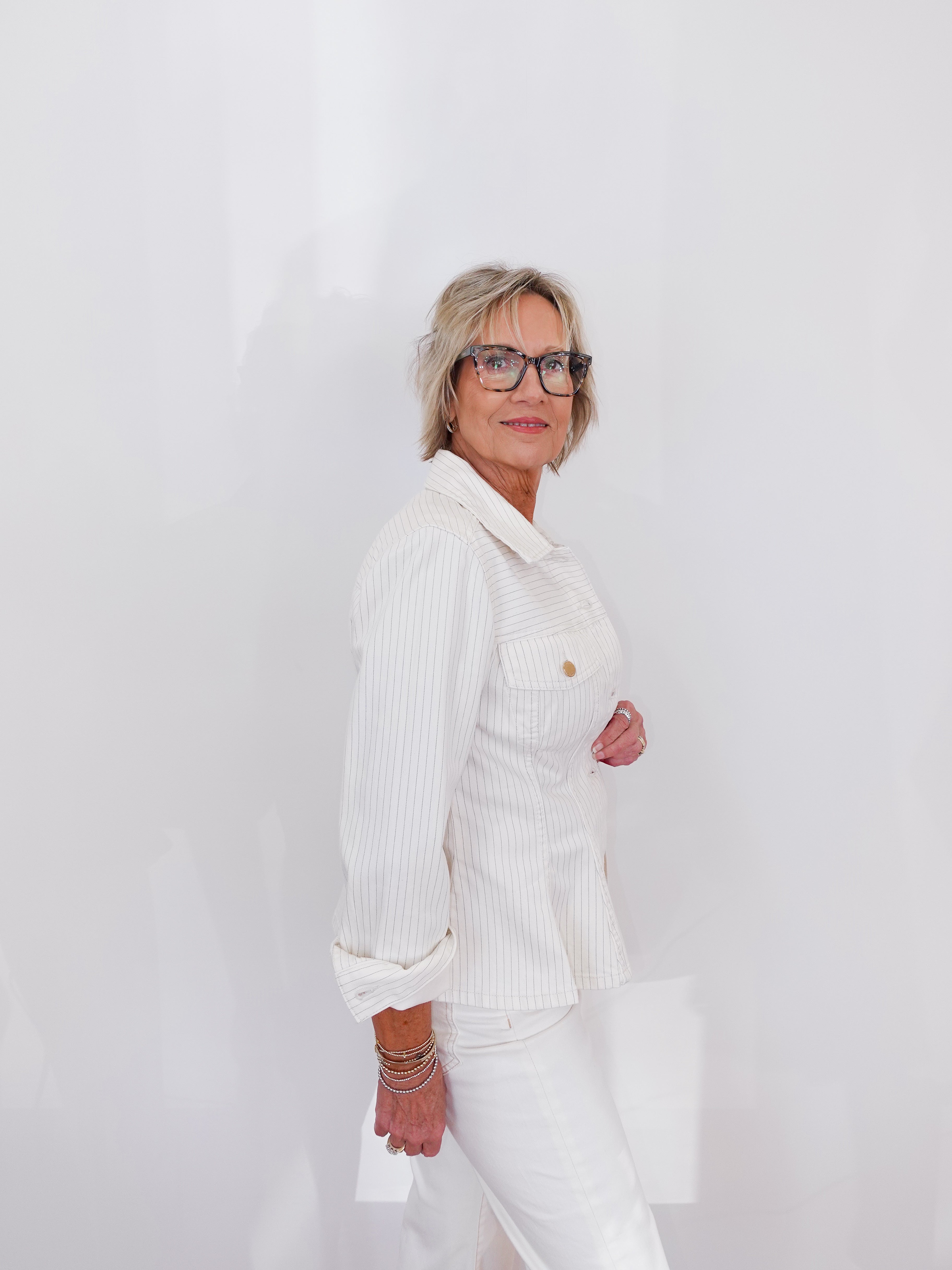 Person wearing a white outfit with a plain background