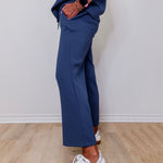 Model showcasing Liverpool pacific blue wide leg crop pull-on pants in front of white wall