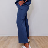 Model showcasing Liverpool pacific blue wide leg crop pull-on pants in front of white wall