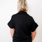 Person wearing a black shirt against a white background