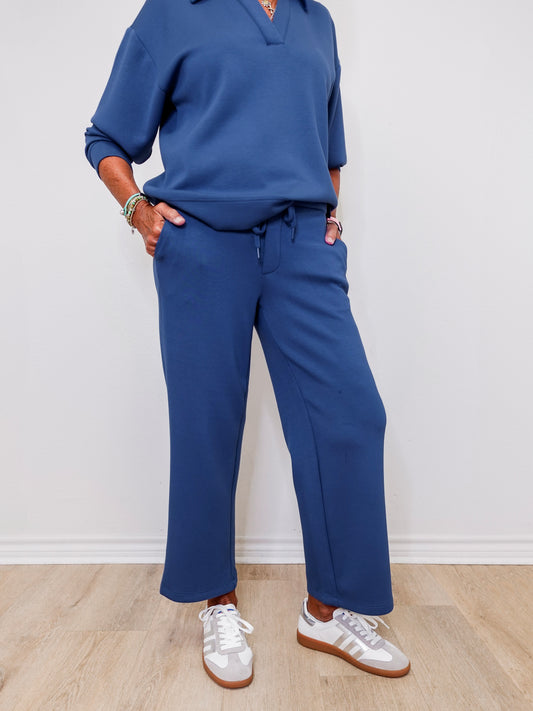 Woman wearing Liverpool pacific blue pull-on wide leg crop pants standing against a white wall