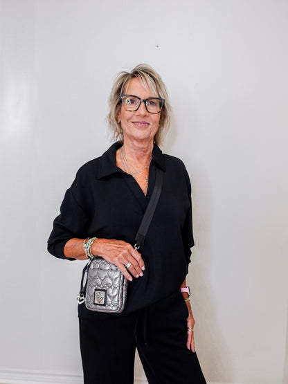women modeling a black v neck sweatshirt in black
