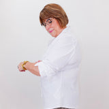 Person wearing a white shirt and leopard print pants against a white background