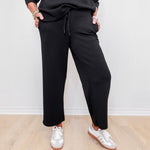 women wearing black pull on pants in the color black. 