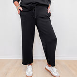 women wearing black pull on pants in the color black. 