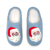 Pair of blue slippers with Santa Claus face design on a white background