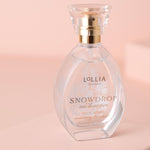Lollia Snowdrop eau de parfum bottle on a pink background