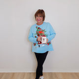 woman wearing a blue top against a white background. 