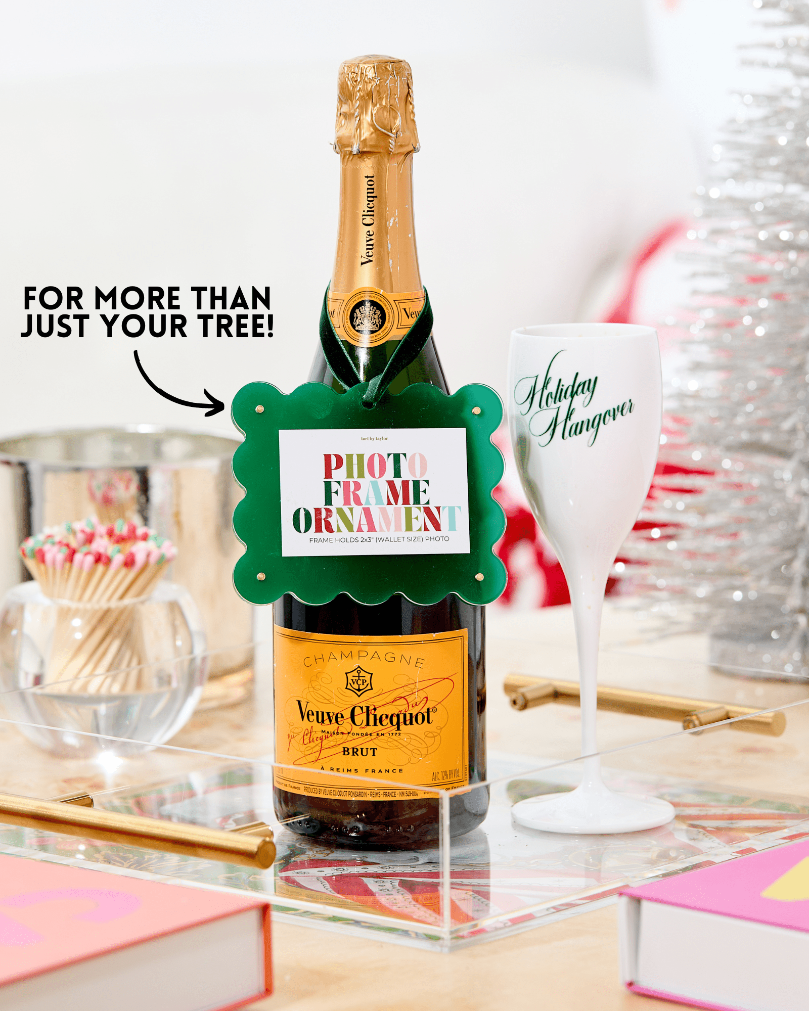 Veuve Clicquot champagne bottle with a decorative tag on a table setting.