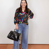 model wearing the johnny was margot silvana blouse with colorful paisley print styled with wide leg denim