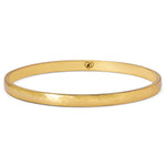 Gold bangle on a white background