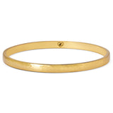 Gold bangle on a white background