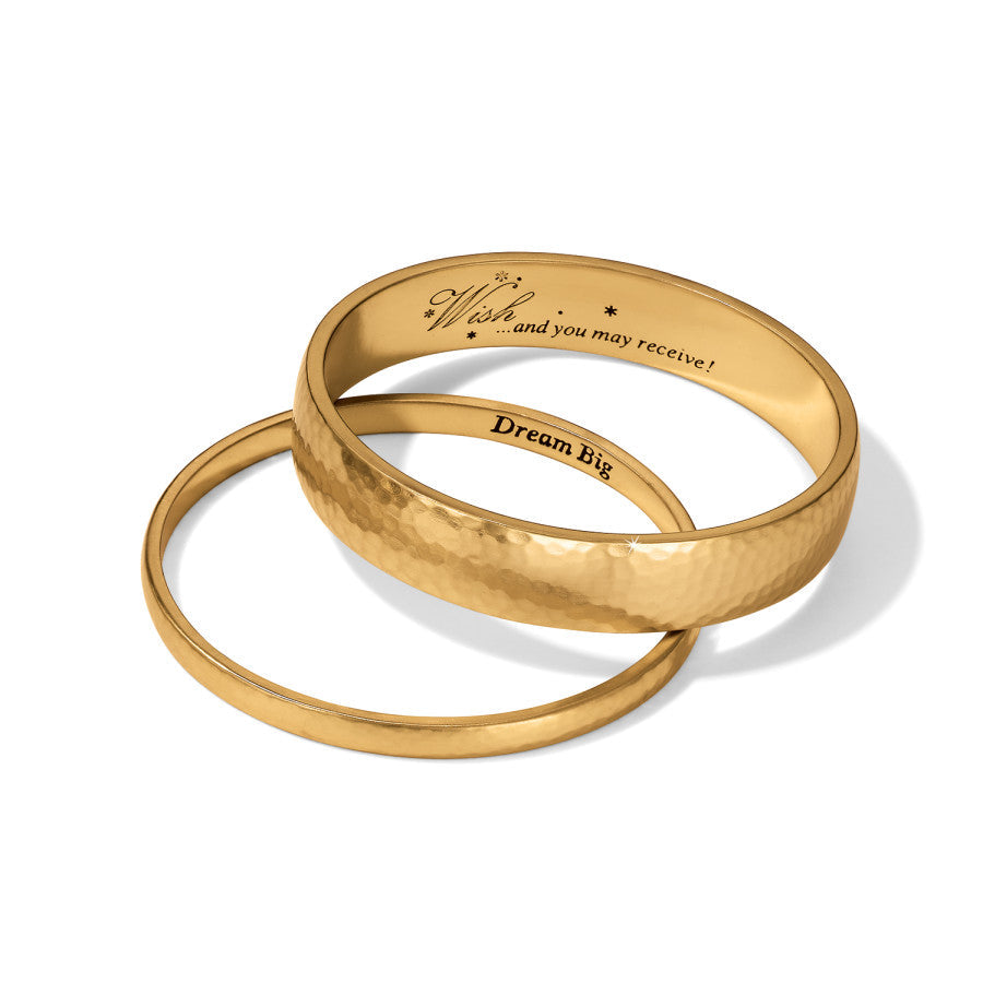 Two gold rings with engraved text on a white background