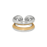 Two rings, one silver and one gold, on a white background