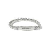 Silver ring with 'Blessed' engraving on a white background