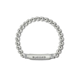 Silver beaded bracelet with a 'blessed' tag on a white background