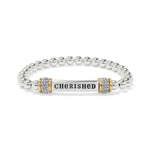 Silver beaded bracelet with a gold and silver bar charm displaying the word 'CHERISHED'.