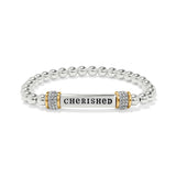 Silver beaded bracelet with a gold and silver bar charm displaying the word 'CHERISHED'.