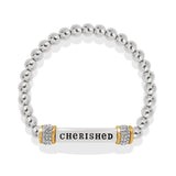 Silver beaded bracelet with a central bar engraved with 'CHERISHED' on a white background