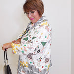 Woman wearing a patterned jacket with a white background