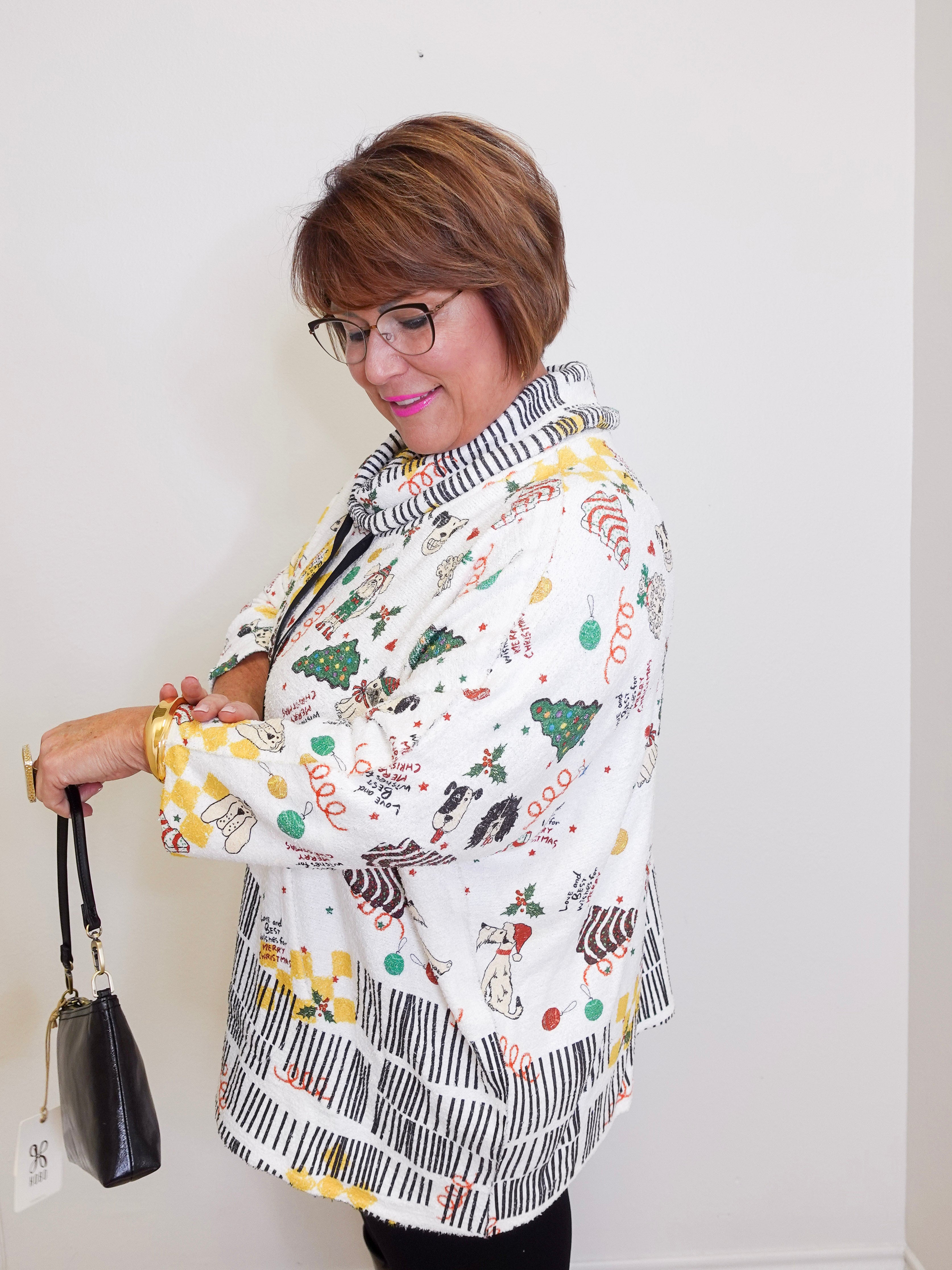 Woman wearing a patterned jacket with a white background