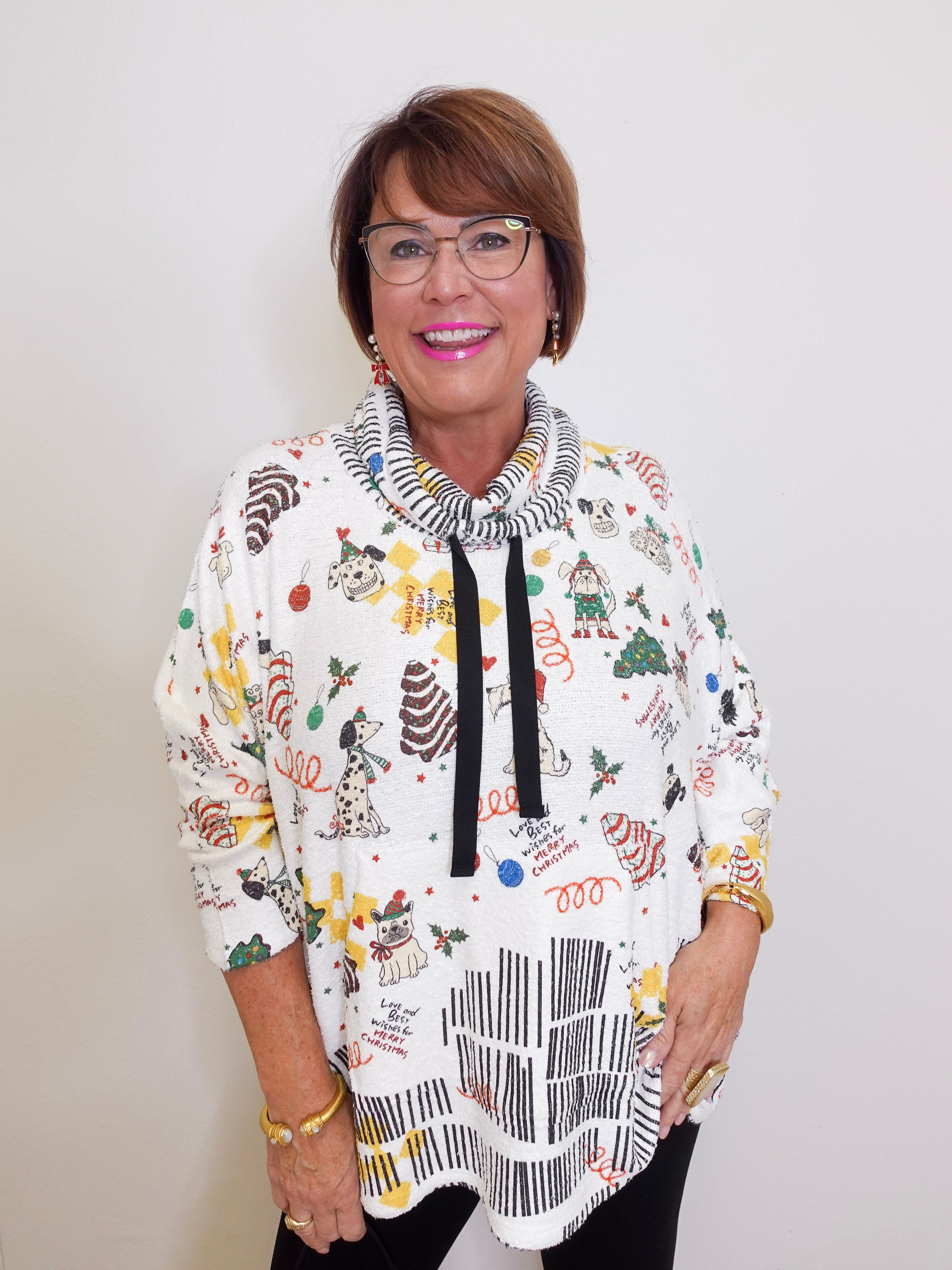 Woman wearing a colorful patterned sweater with a white background