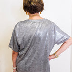 woman wearing a metallic blouse 
