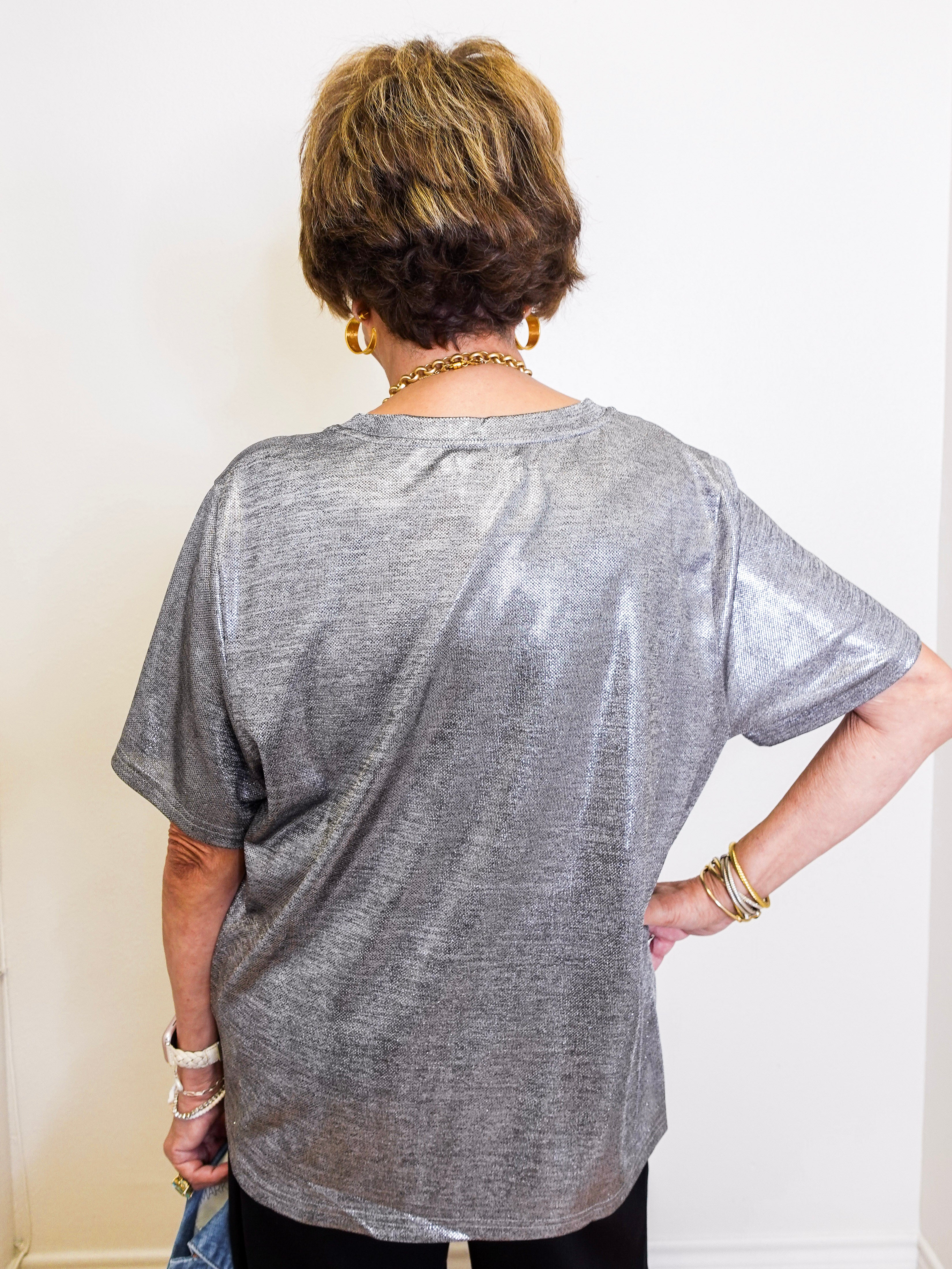 woman wearing a metallic blouse 