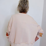 woman wearing a pumpkin sequin sweatshirt