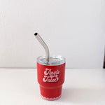 Red cup with 'Jingle Juice' text and metal straw on a white background