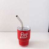 Red cup with 'Jingle Juice' text and metal straw on a white background