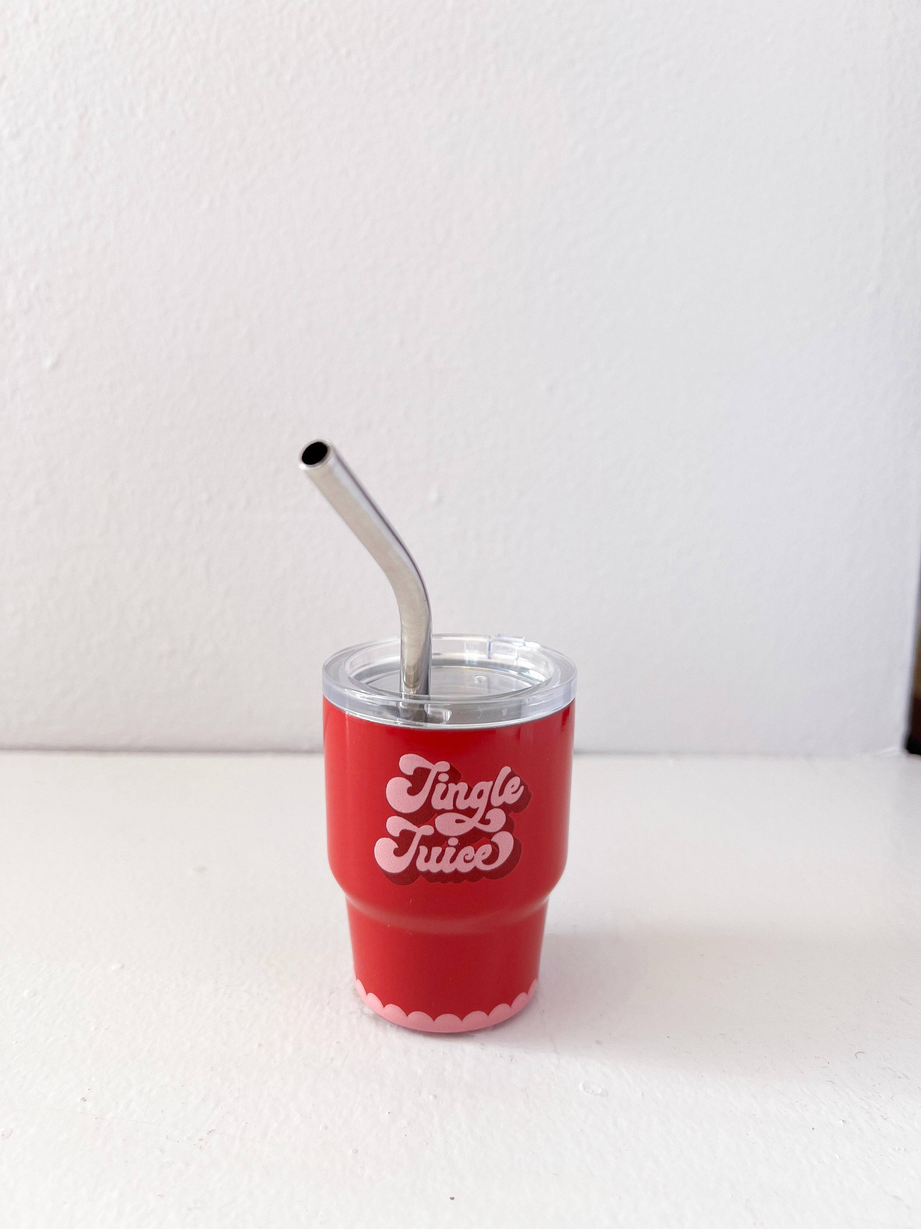 Red cup with 'Jingle Juice' text and metal straw on a white background