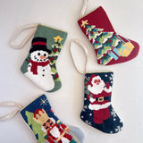 Four colorful Christmas stockings with festive designs on a white background