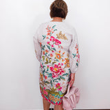 Person wearing a floral dress with a white background