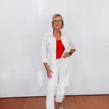 Woman in a white outfit with a red top against a white background