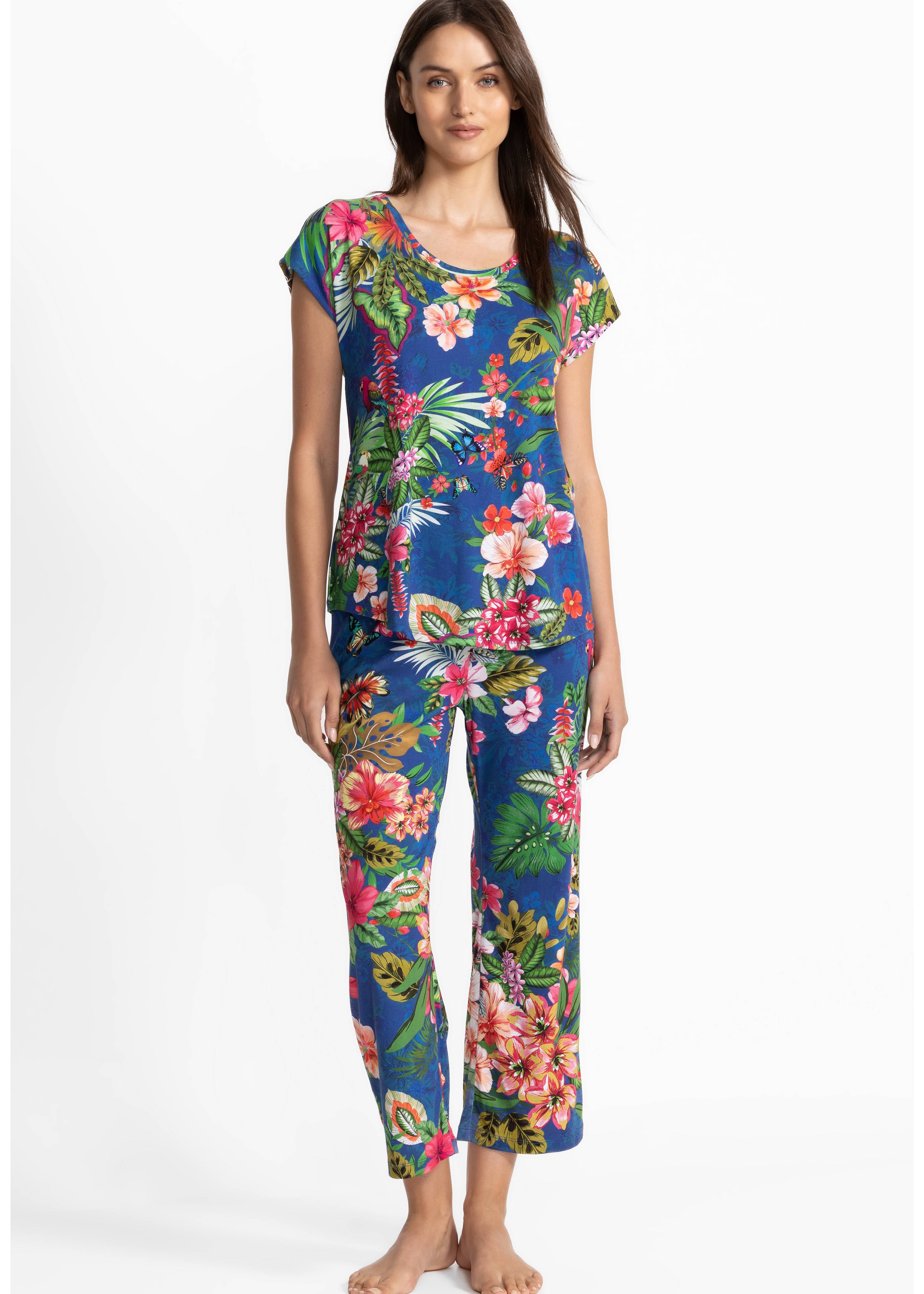 Woman wearing a colorful floral pajamas on a white background