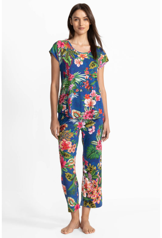 Woman wearing a colorful floral pajamas on a white background